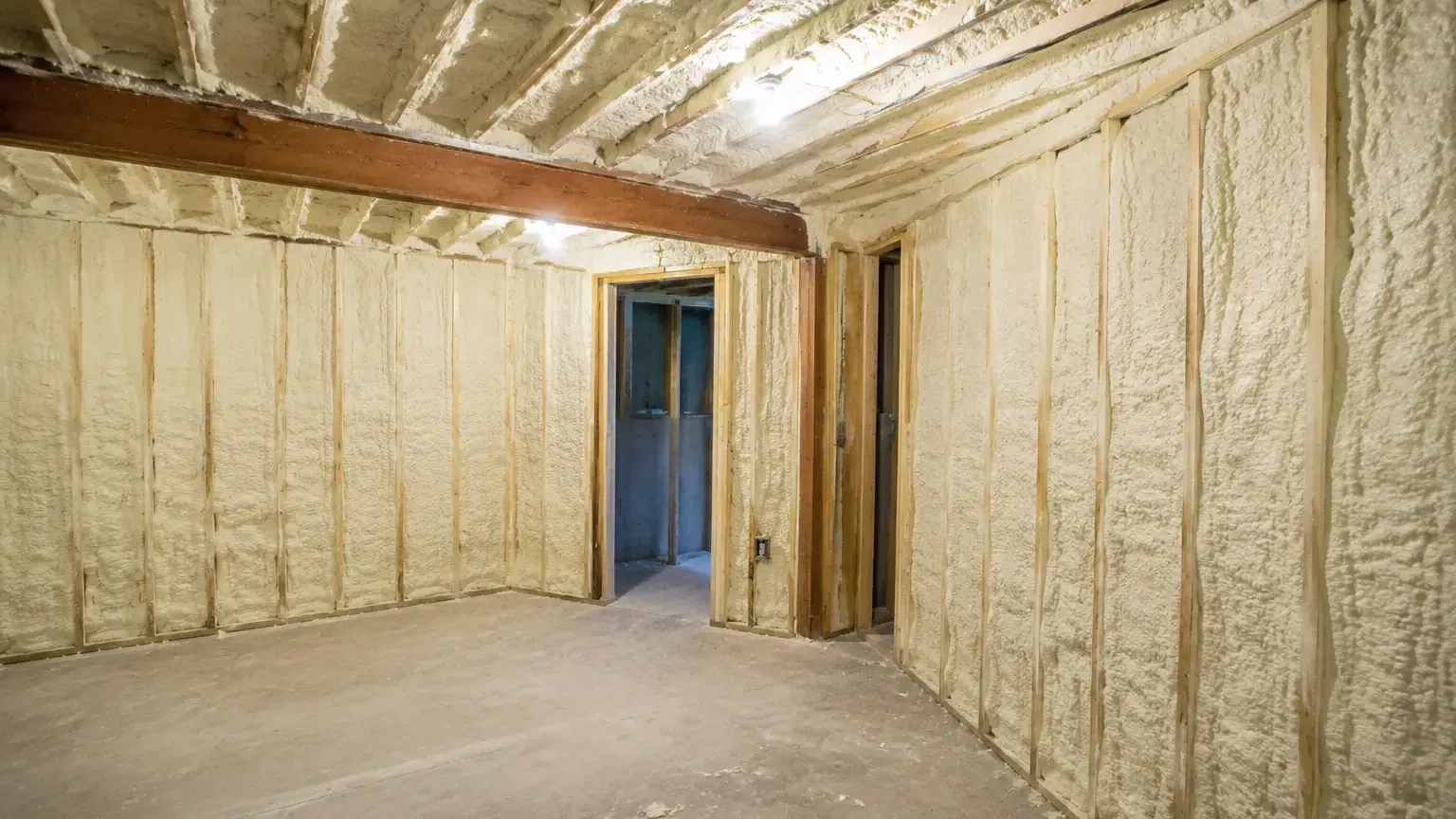 Closed-cell spray foam filling stud bays in a conversion