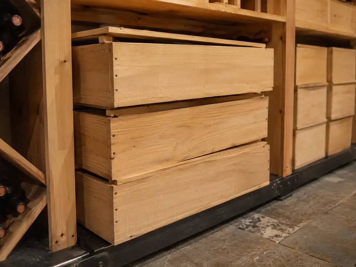 Wooden wine cases stacked in cellar case storage